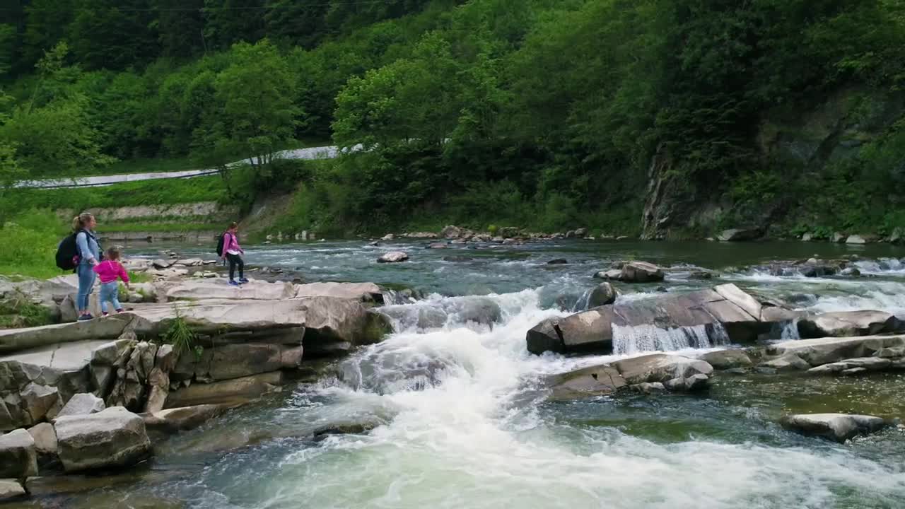 Stock Video Mother And Daughters Next To A River In The Fores Animated Wallpaper