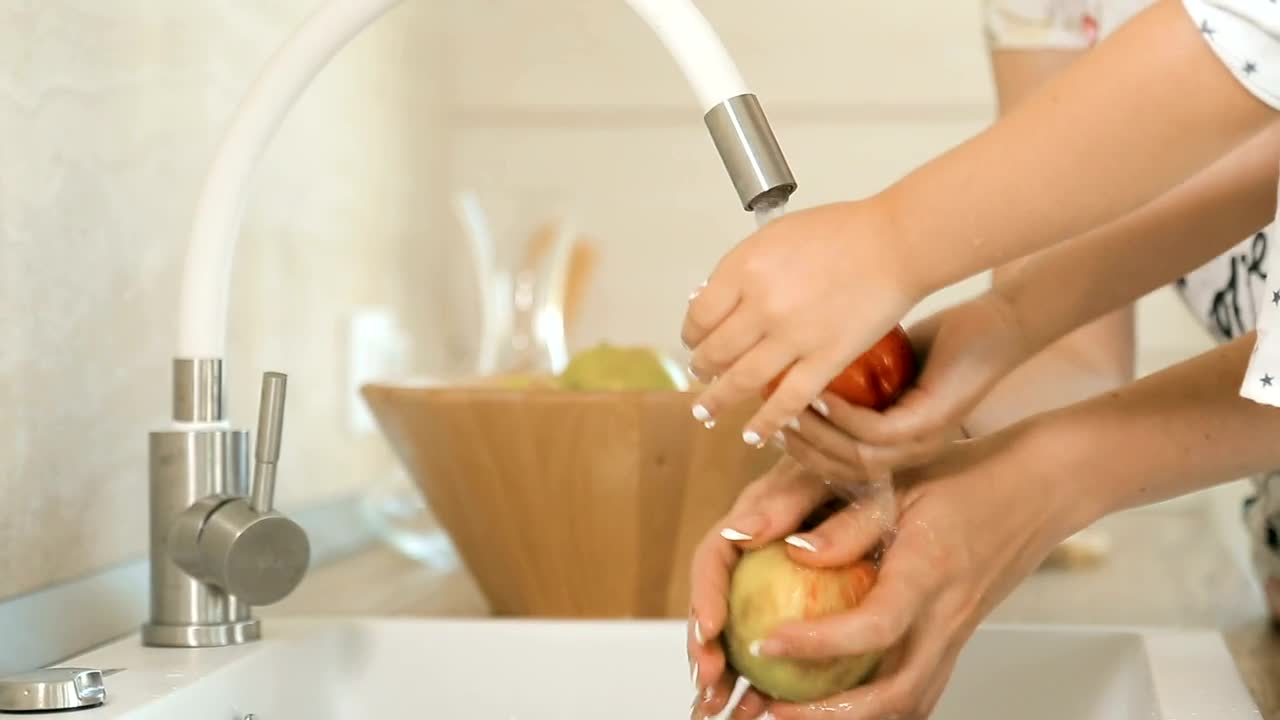Stock Video Mother And Daughter Washing Apple Animated Wallpaper