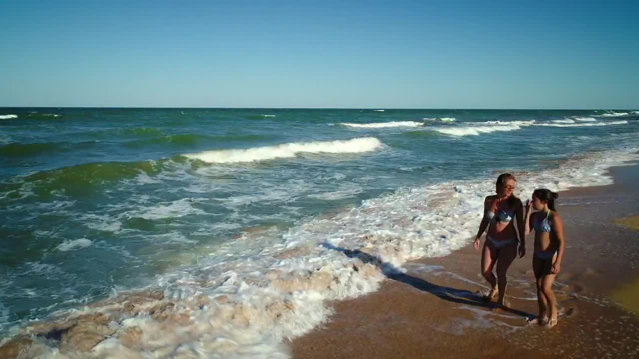 Stock Video Mother And Daughter Talk And Walk On The Seashor Animated Wallpaper