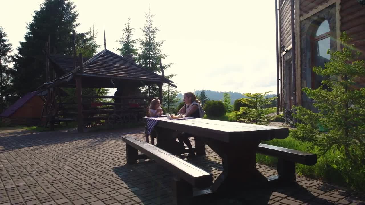 Stock Video Mother And Daughter At Lunch On An Outdoor Benc Animated Wallpaper