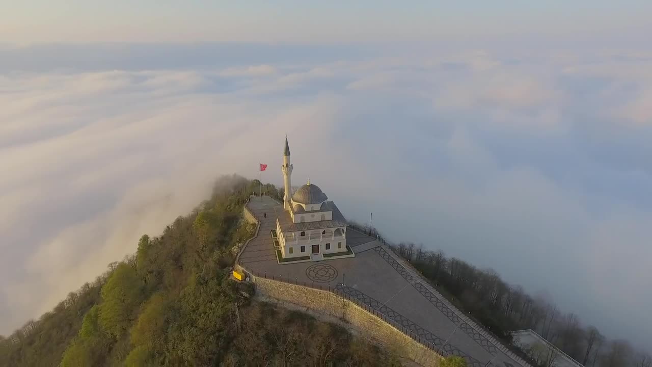 Stock Video Mosque Building At The Top Of A Cloudy Mountai Animated Wallpaper