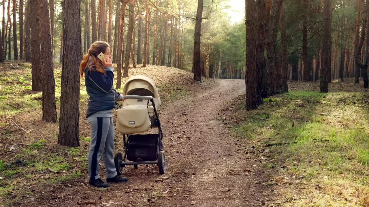 Stock Video Mom Talking On The Phone In The Wood Animated Wallpaper