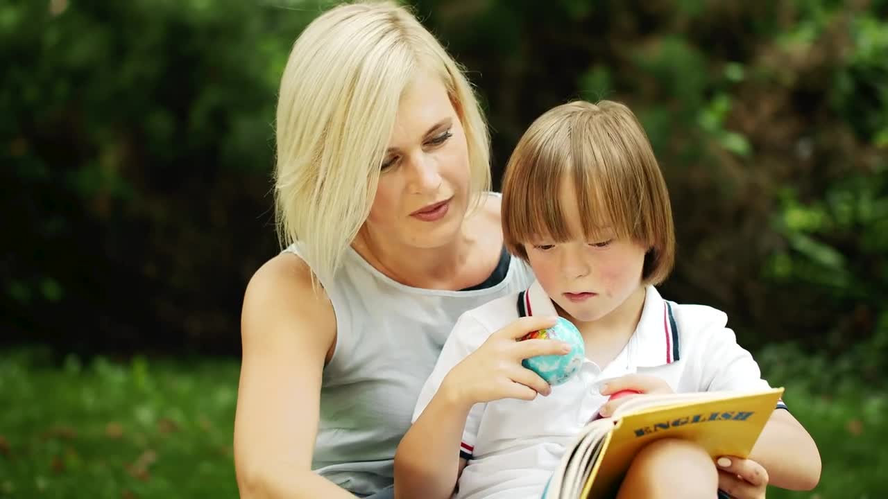 Stock Video Mom Helps Little Boy With English Educatio Animated Wallpaper
