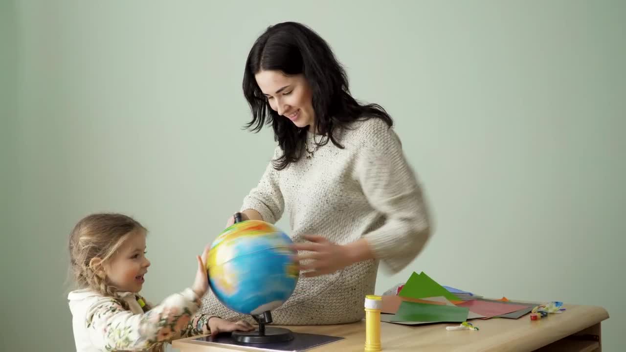 Stock Video Mom And Young Daughter Spin World Glob Animated Wallpaper
