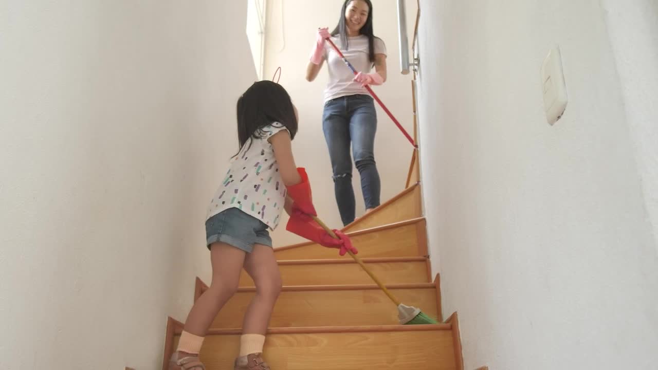 Stock Video Mom And Daughter Sweeping The Stairs At Hom Animated Wallpaper