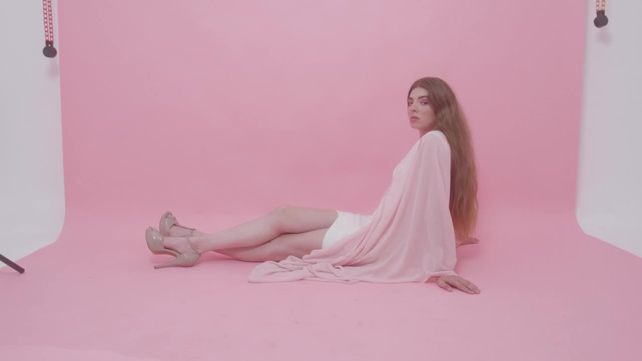 Stock Video Model Posing On The Floor Of A Photographic Se Animated Wallpaper