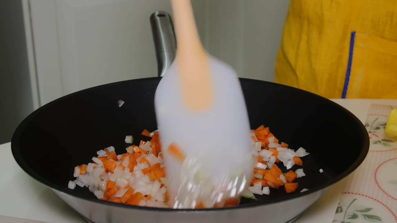 Stock Video Mixing Chopped Vegetables In A Frying Pa Animated Wallpaper