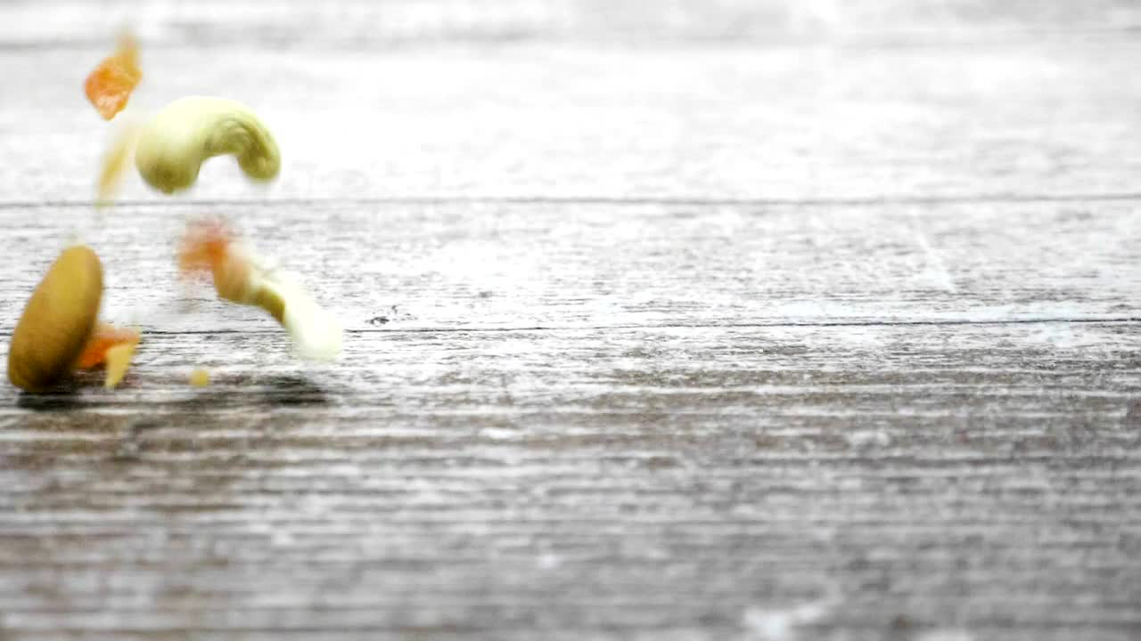Stock Video Mixed Nuts Falling Onto A Tabl Animated Wallpaper