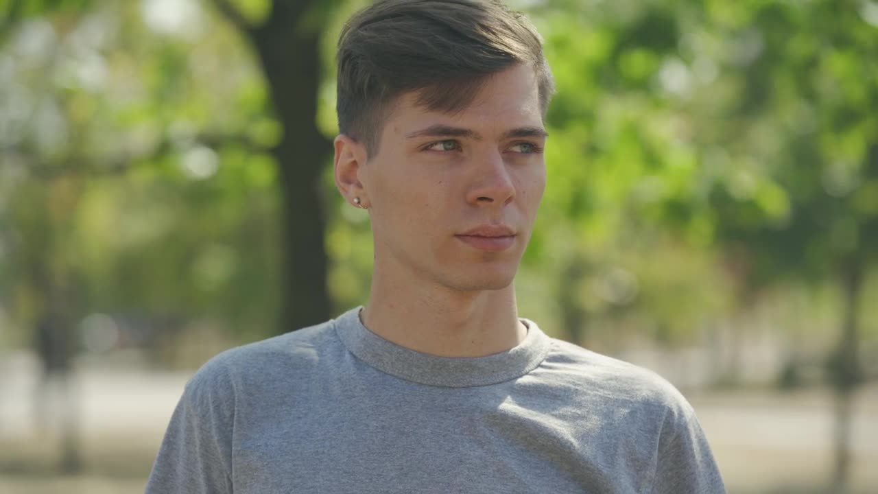 Stock Video Millennial Man Smiles At Camera In Outdoor Portrai Animated Wallpaper