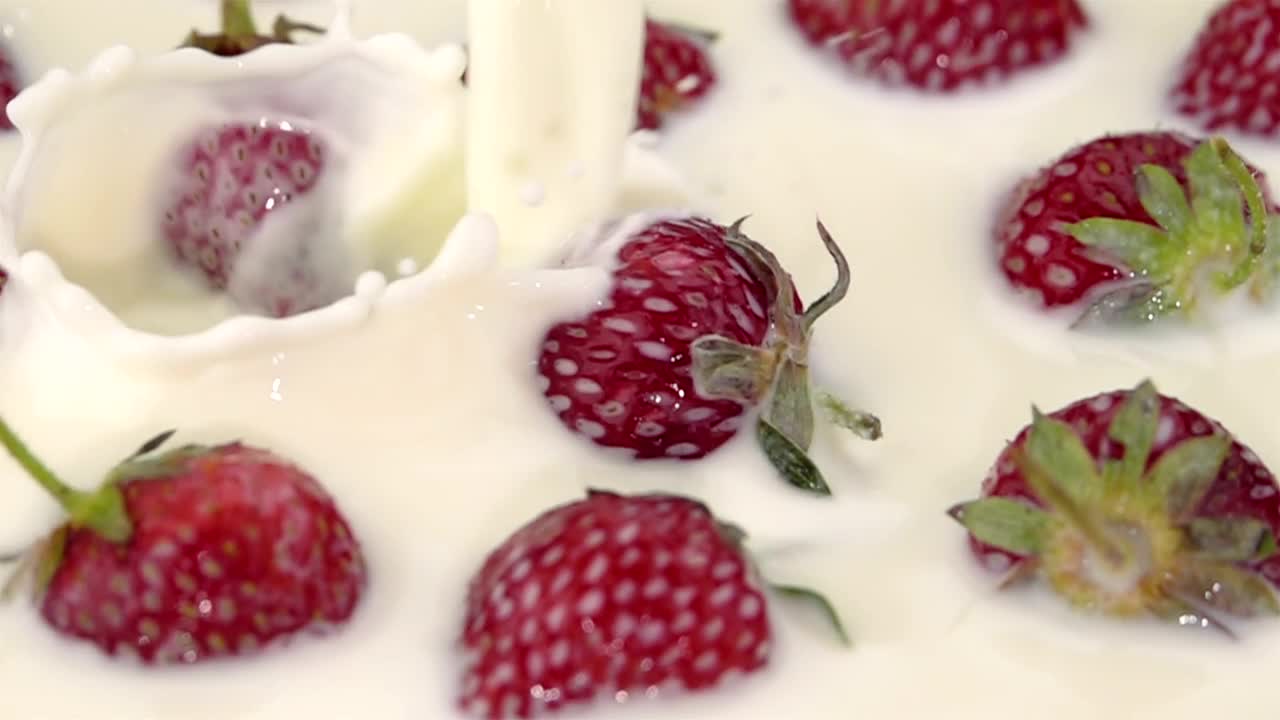 Stock Video Milk Poured On Strawberrie Animated Wallpaper