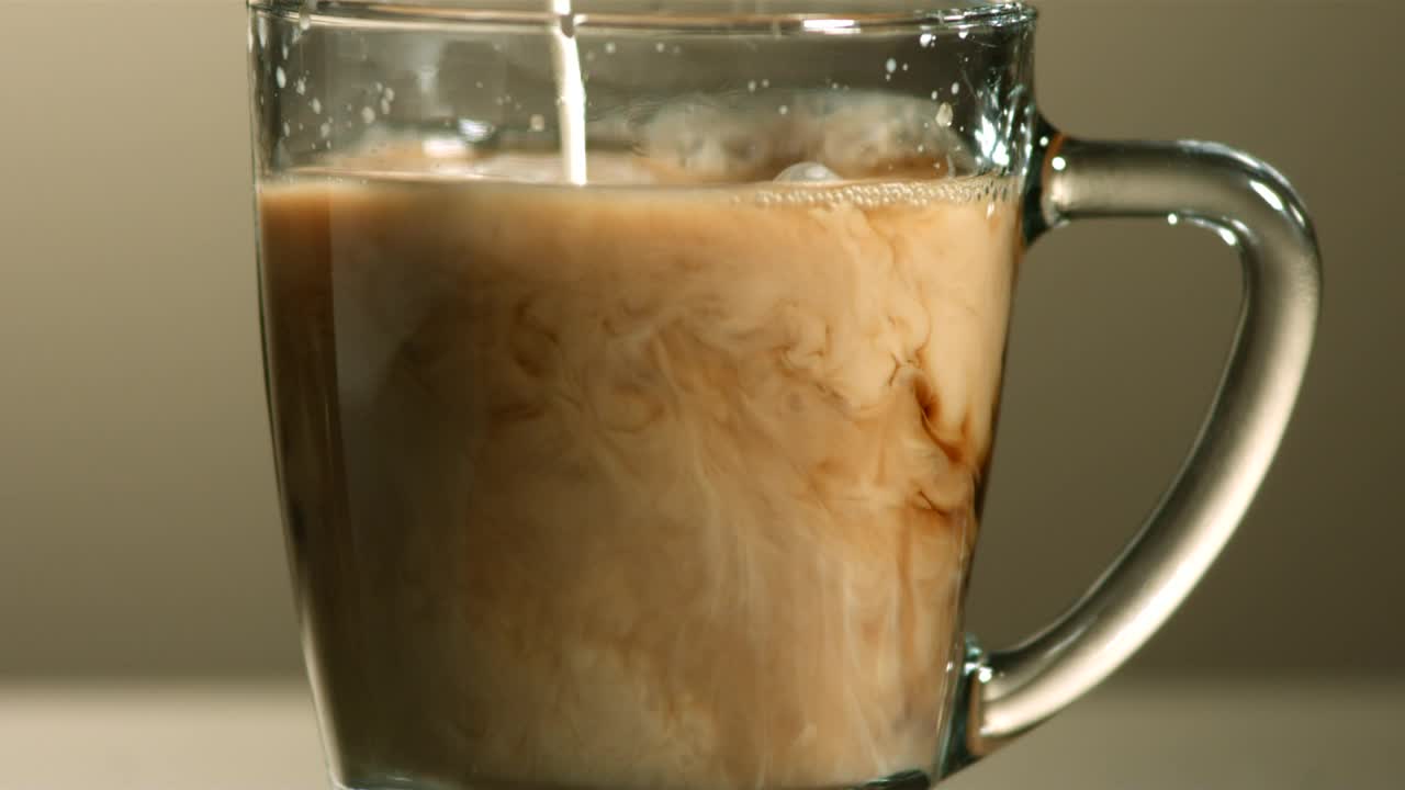 Stock Video Milk Poured Into Coffee In Slow Motio Animated Wallpaper