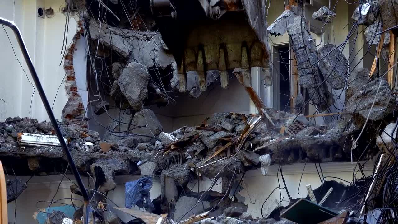 Stock Video Mechanical Arm Of A Bulldozer Knocking Down Debri Animated Wallpaper