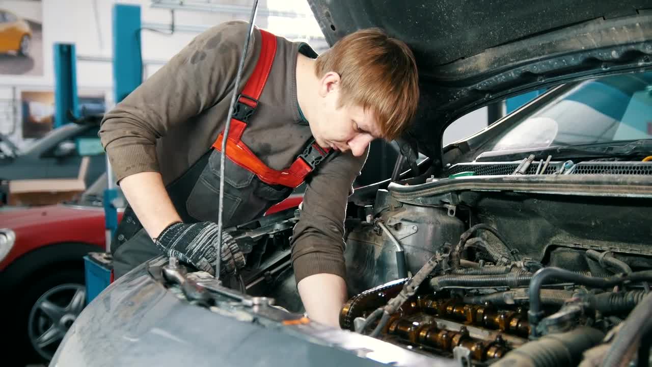 Stock Video Mechanic Working Under The Hood Of A Ca Animated Wallpaper