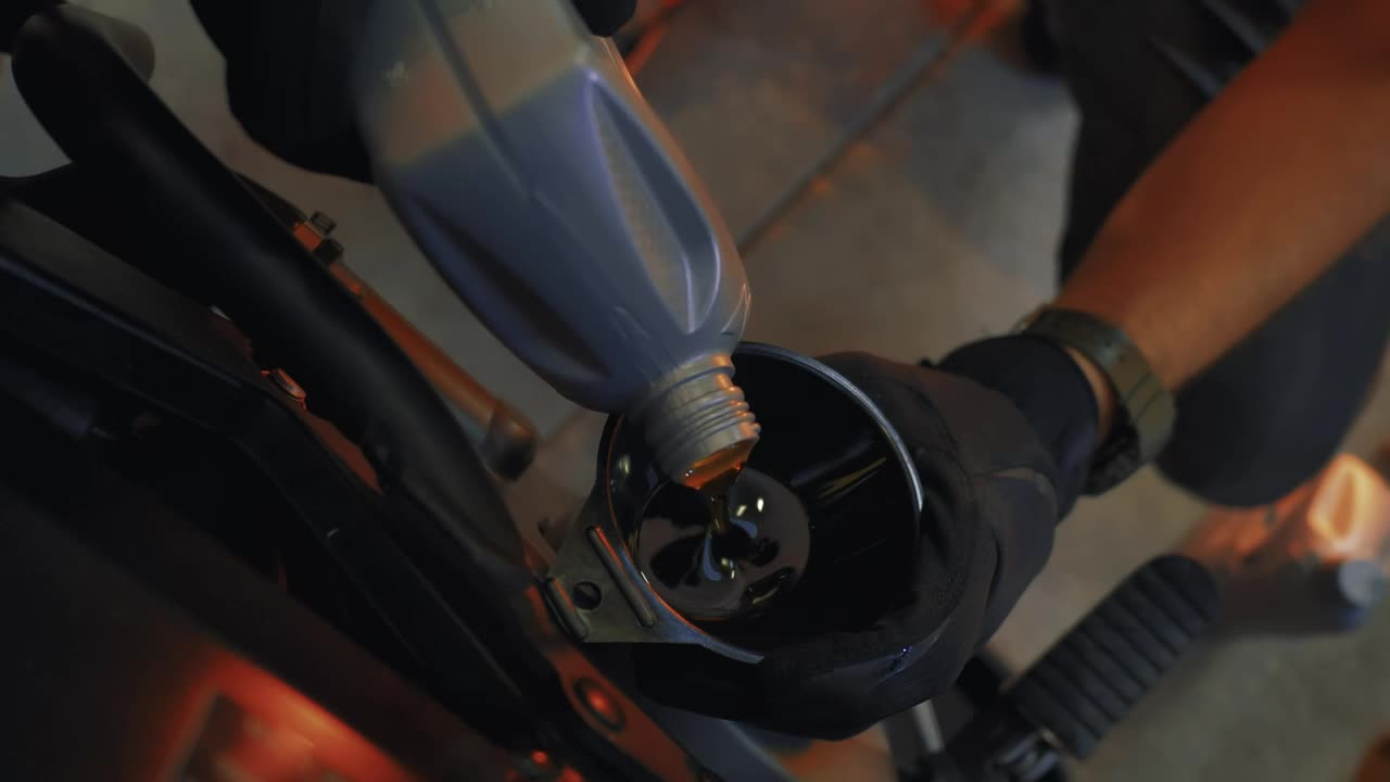 Stock Video Mechanic Pouring Oil Into An Engin Animated Wallpaper