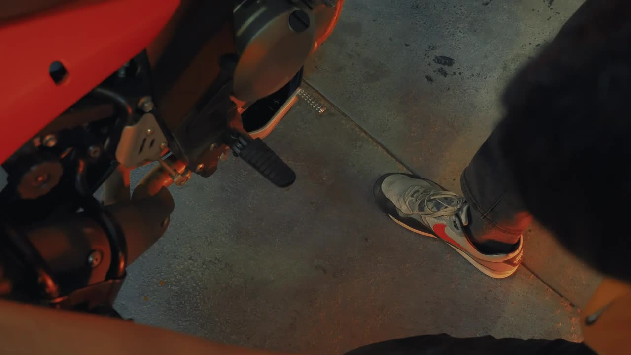 Stock Video Mechanic Looking At A Motorcycle In A Worksho Animated Wallpaper