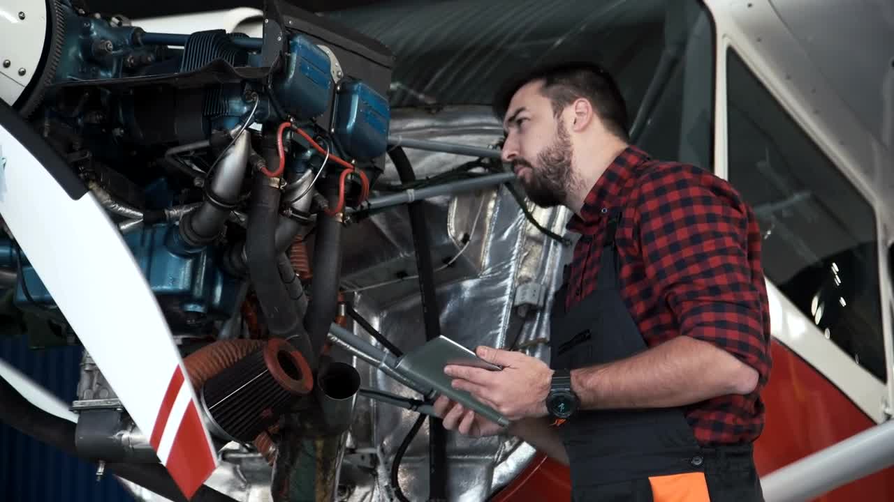Stock Video Mechanic Inspecting An Airplane Engin Animated Wallpaper