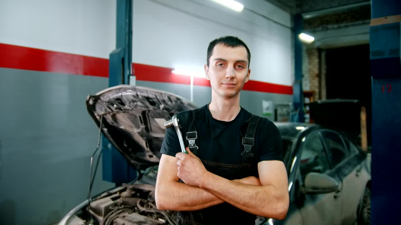 Stock Video Mechanic Holding A Repair Tool With A Broken Car I Animated Wallpaper