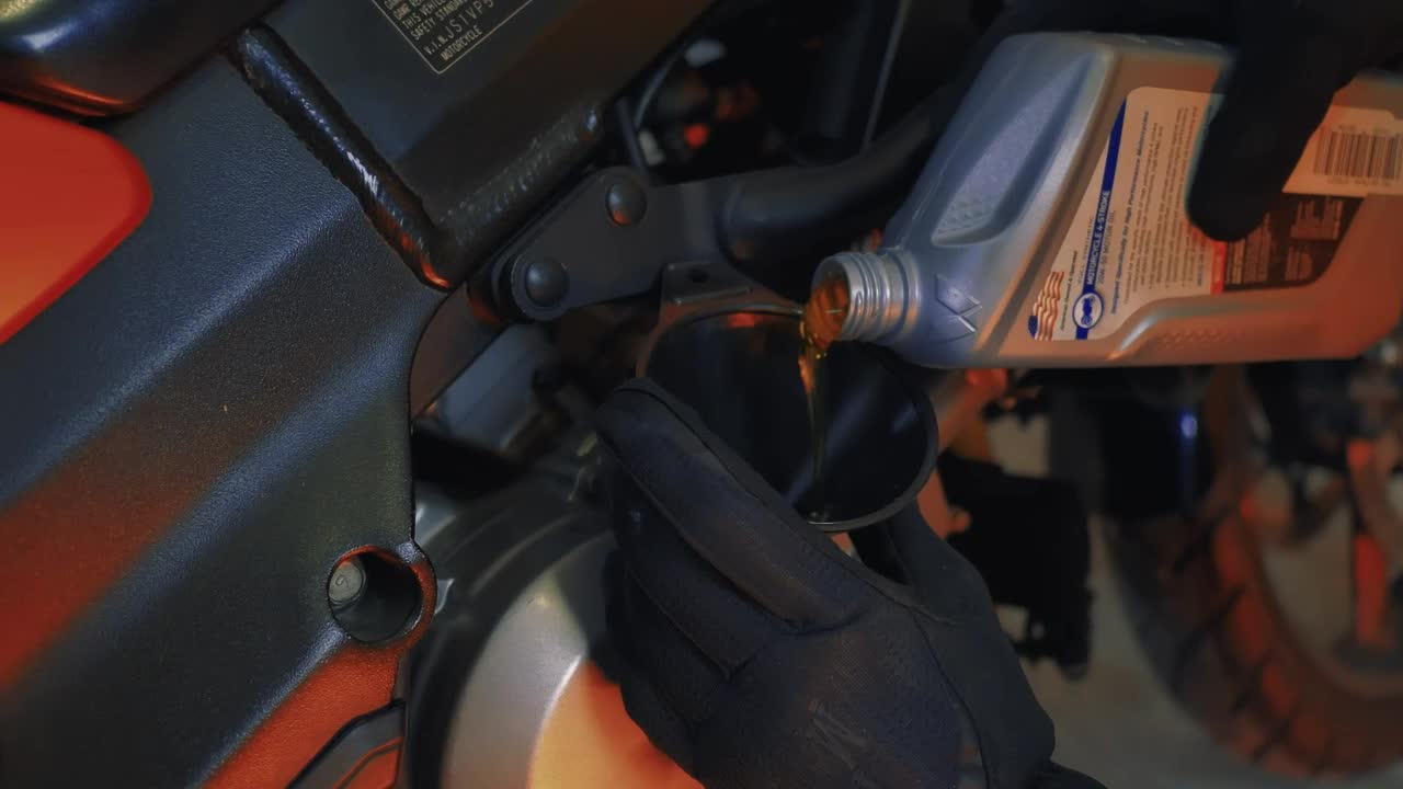 Stock Video Mechanic Changing The Oil Of A Motorcycl Animated Wallpaper