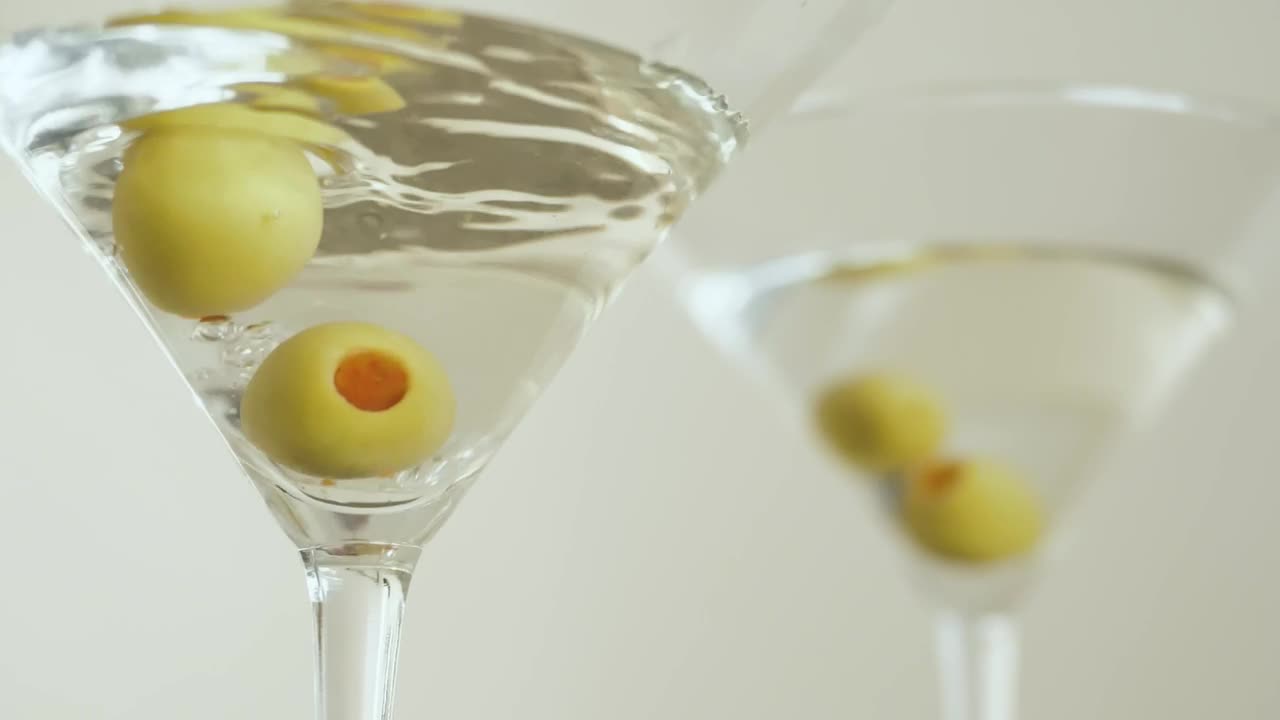 Stock Video Martini Glasses With Olives On A White Backgroun Animated Wallpaper