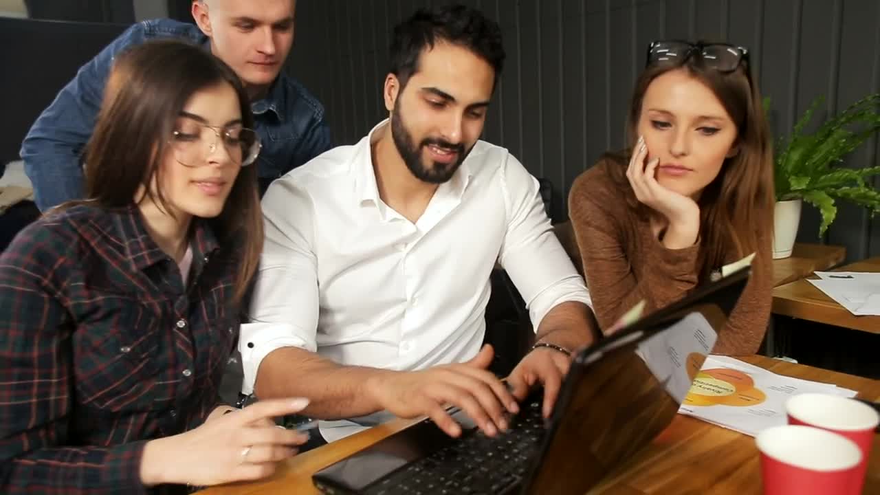 Stock Video Marketing Team Gather Around Laptop And Smile At Camer Animated Wallpaper