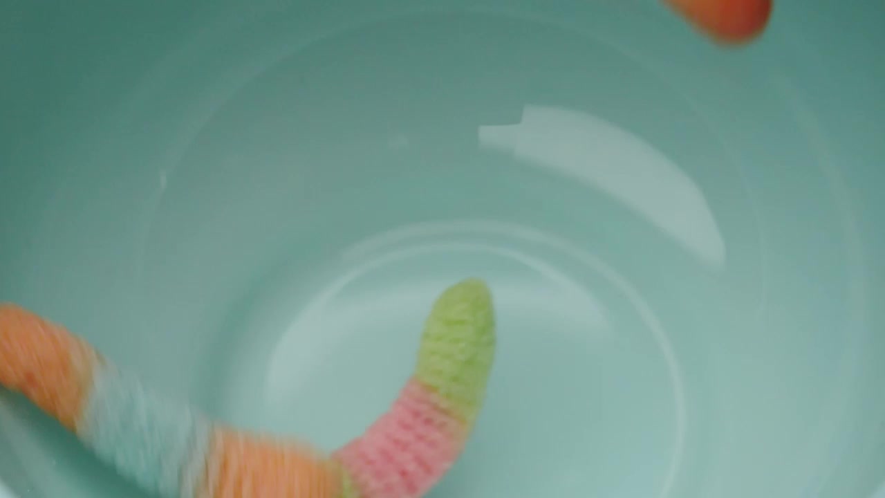 Stock Video Many Sugary Gum Worms Falling Into A Bow Animated Wallpaper