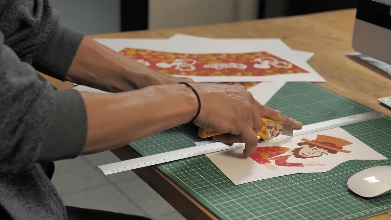 Stock Video Mans Hands Cut A Printed Illustration With A Cutte Animated Wallpaper