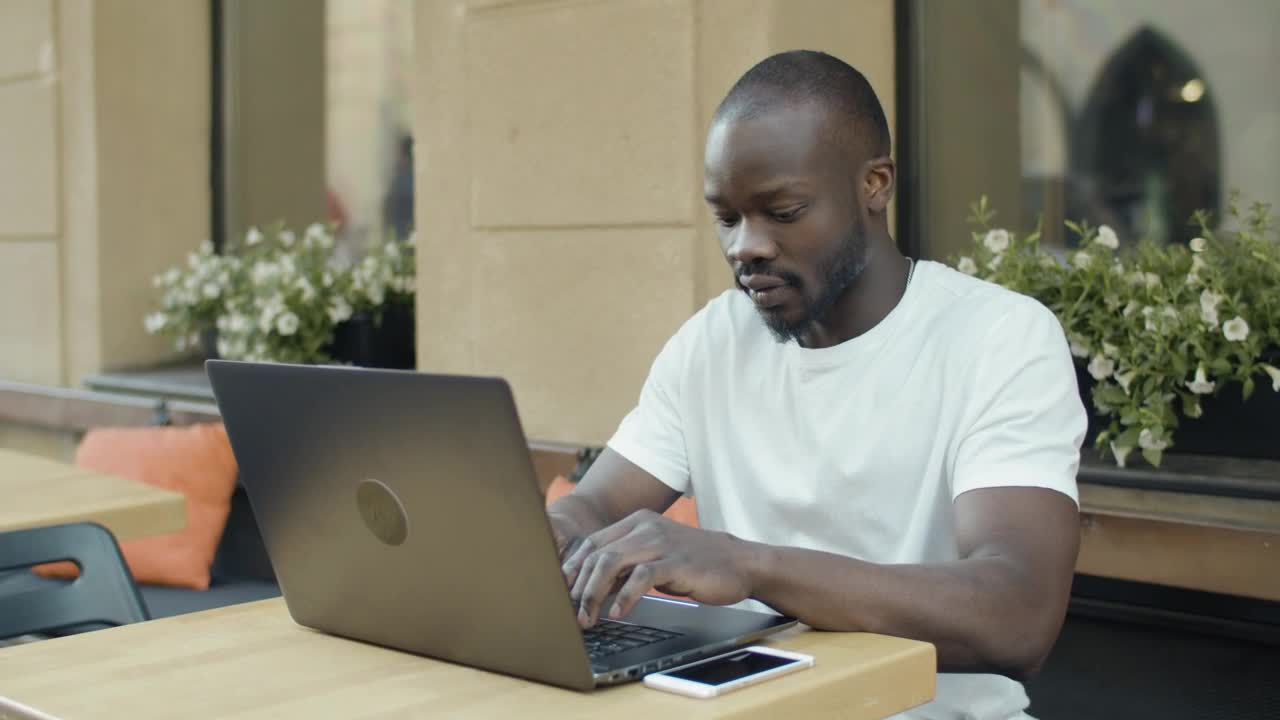 Stock Video Man Working Remotely From A Coffee Sho Animated Wallpaper