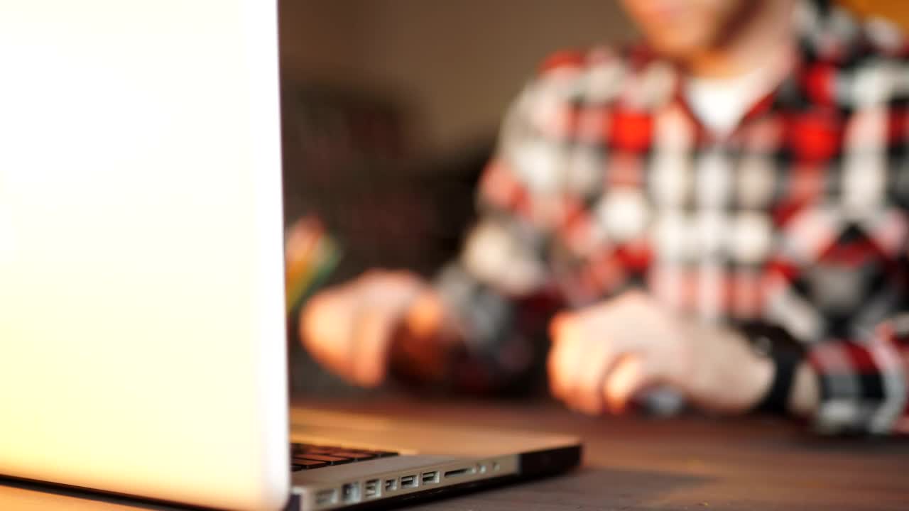 Stock Video Man Working On Laptop Looks At His Smart Watc Animated Wallpaper