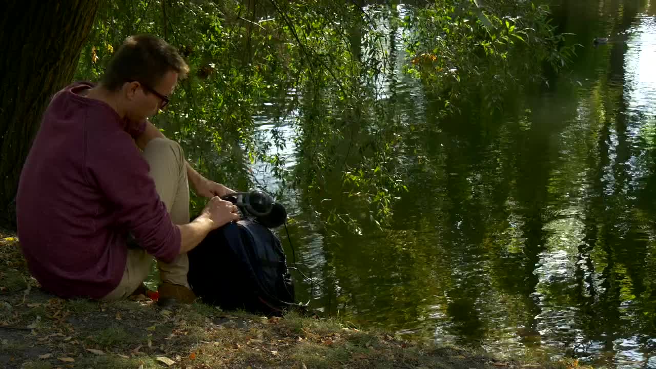 Stock Video Man Working On A Tablet In The Lakeshor Animated Wallpaper