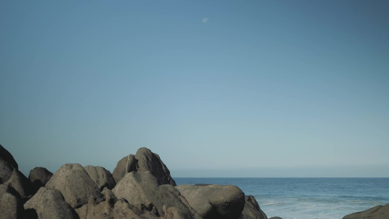 Stock Video Man With Surfboard Stands On Boulder Animated Wallpaper