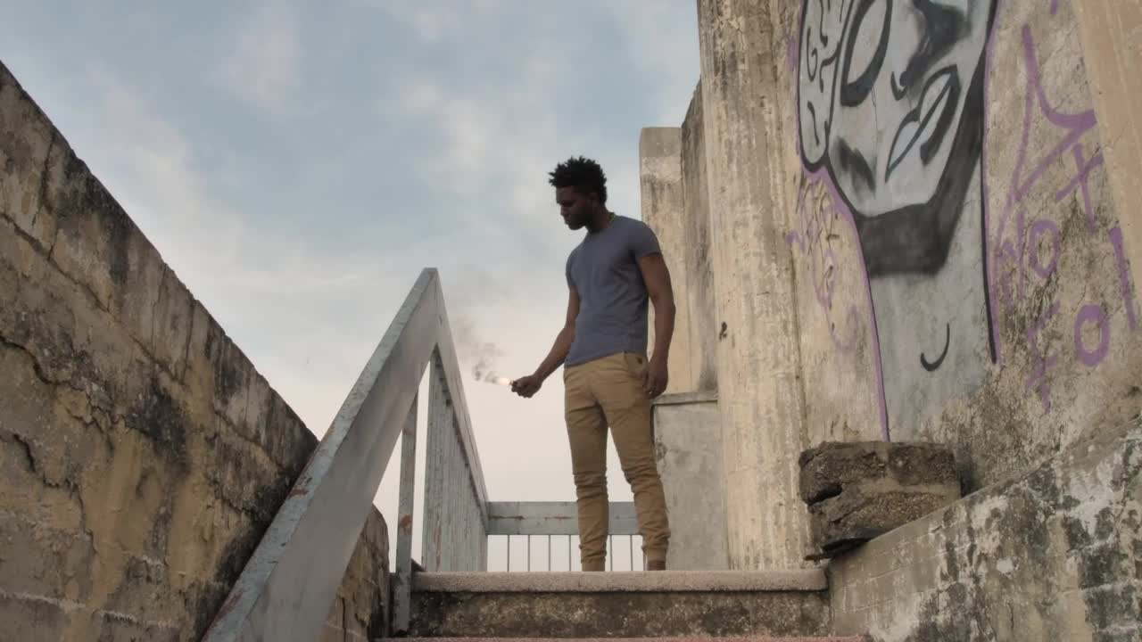 Stock Video Man With Smoke Bomb On Staircas Animated Wallpaper