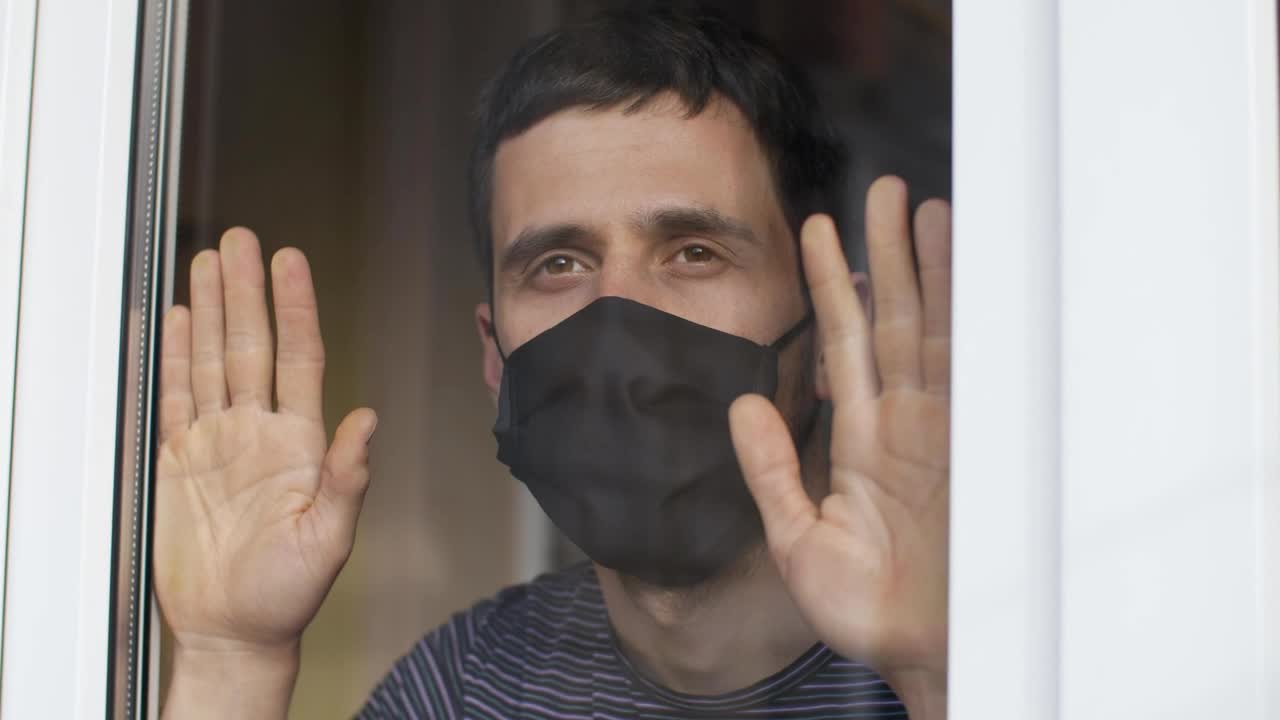 Stock Video Man With Mask Looks Longingly From His Windo Animated Wallpaper