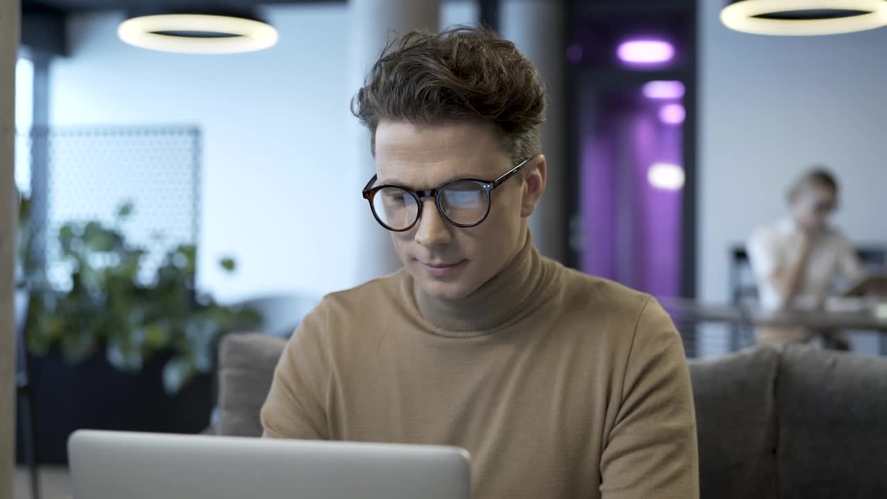 Stock Video Man With Glasses Working On A Lapto Animated Wallpaper