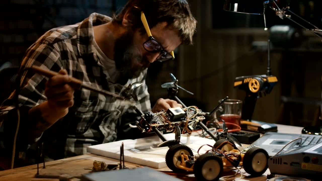Stock Video Man With Glasses Soldering A Drone In The Garag Animated Wallpaper