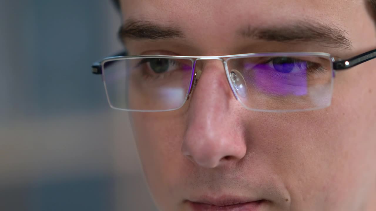 Stock Video Man With Glasses Looking At Monito Animated Wallpaper