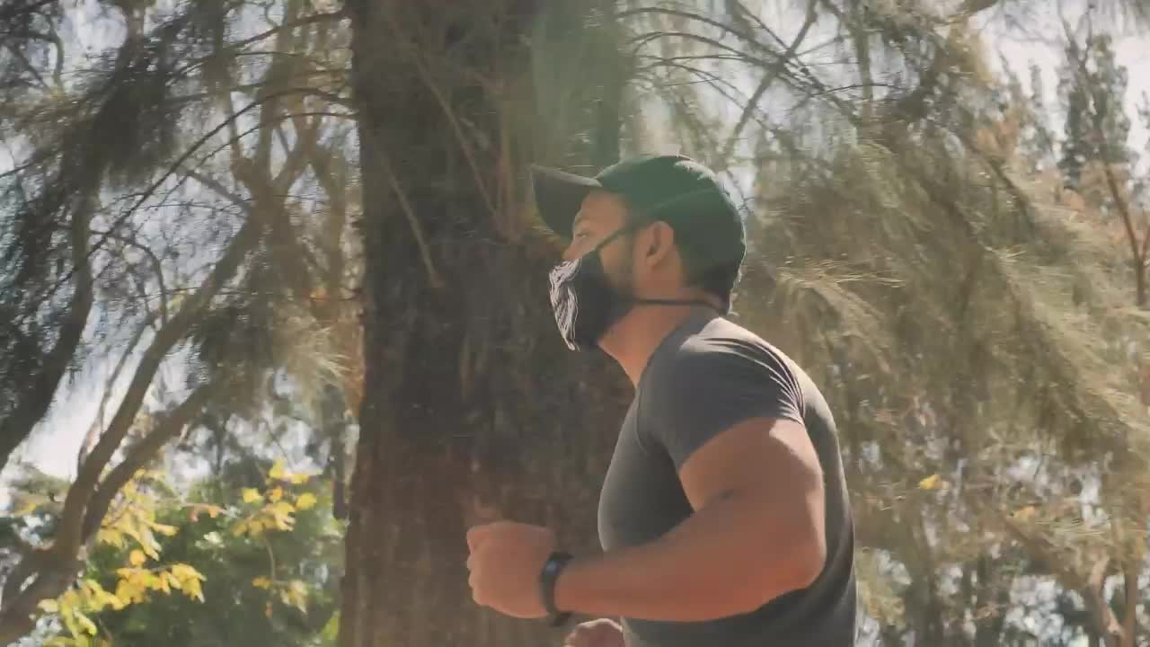 Stock Video Man With Face Mask Running At The Par Animated Wallpaper