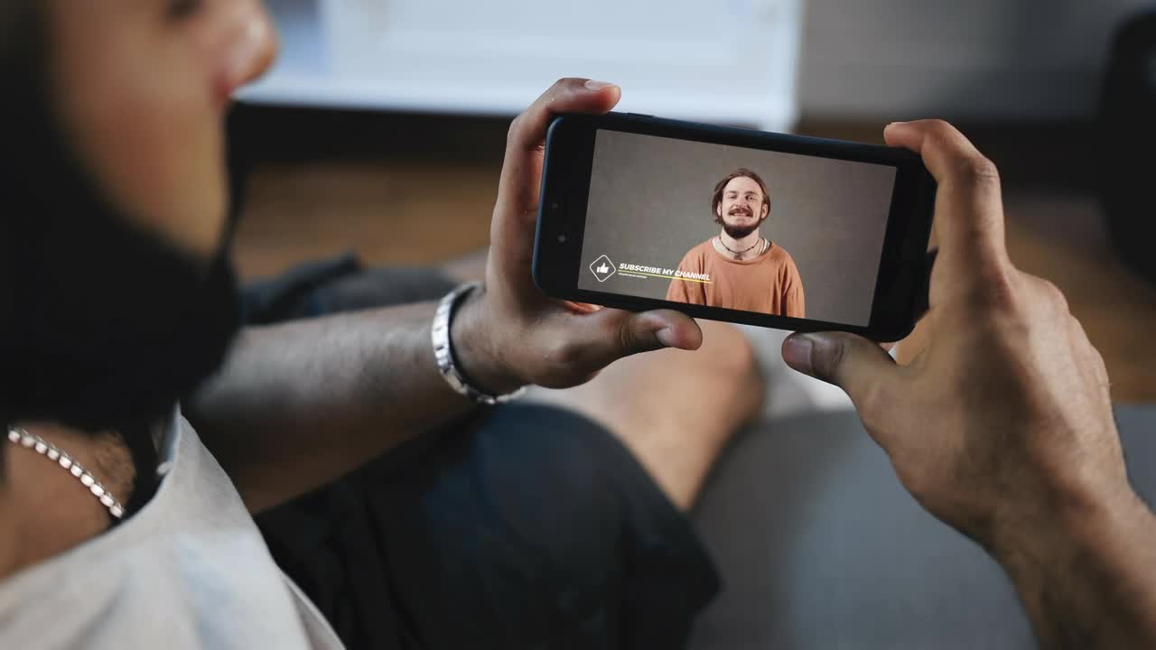 Stock Video Man Watches Social Media Video On Mobile Scree Animated Wallpaper