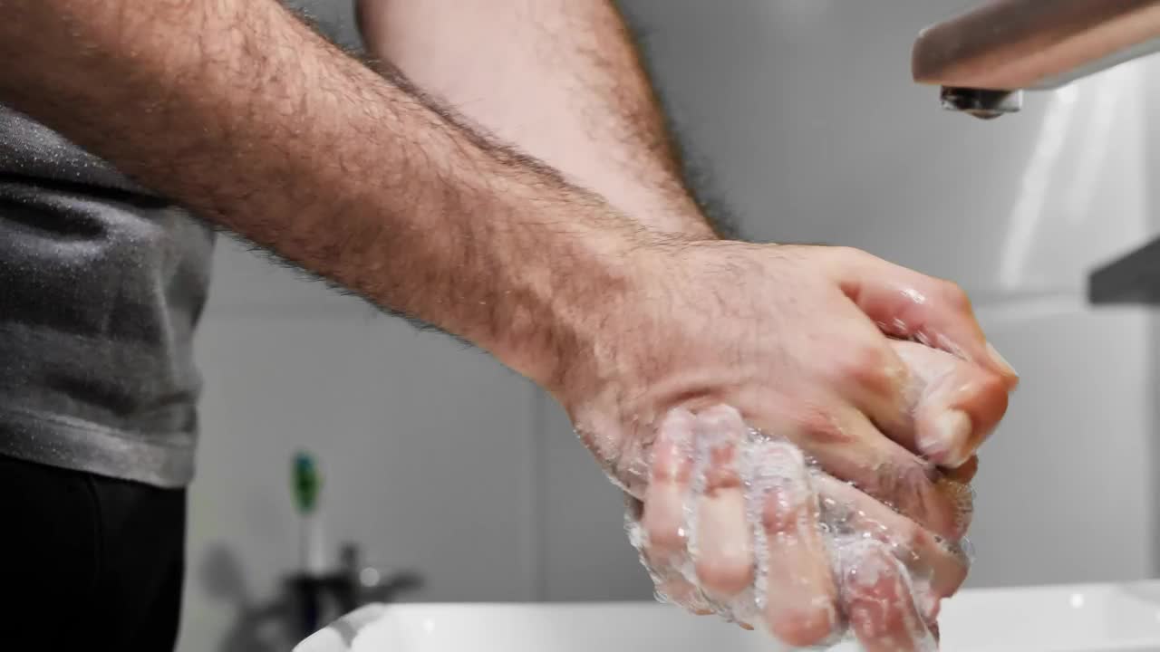Stock Video Man Washing His Hands With Soap Detailed Vie Animated Wallpaper