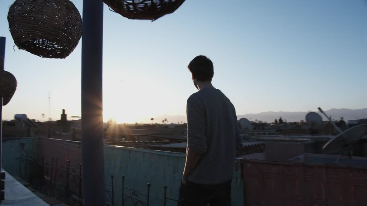 Stock Video Man Walks On The Rooftop With Sunrise Vie Animated Wallpaper