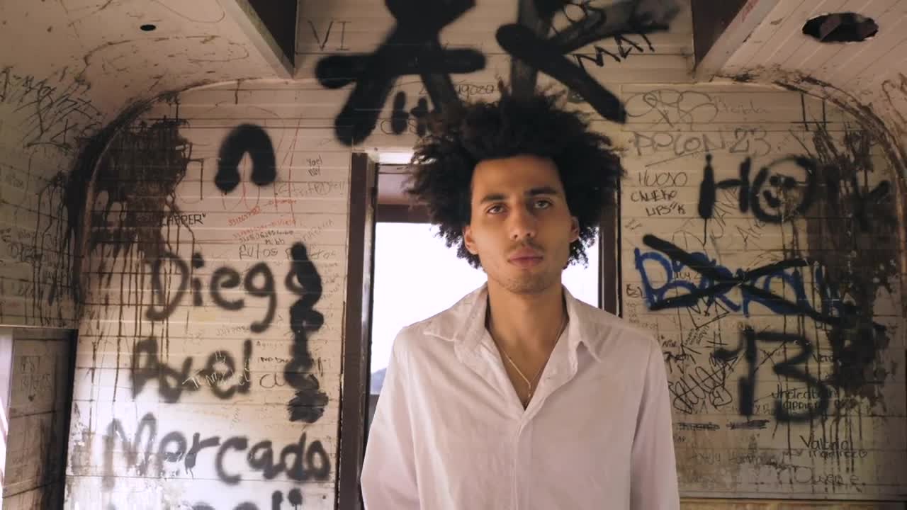 Stock Video Man Walking Through A Graffitied Hal Animated Wallpaper