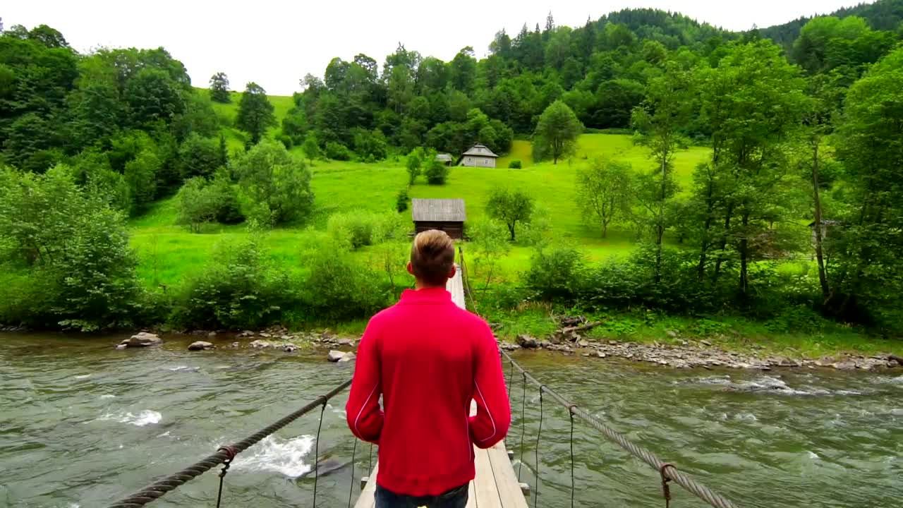 Stock Video Man Walking On A Suspended Bridg Animated Wallpaper