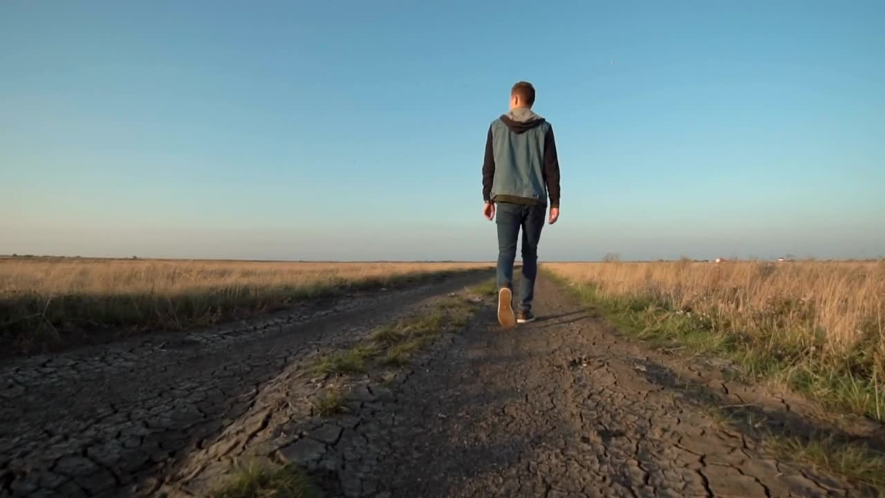 Stock Video Man Walking On A Rural Roa Animated Wallpaper
