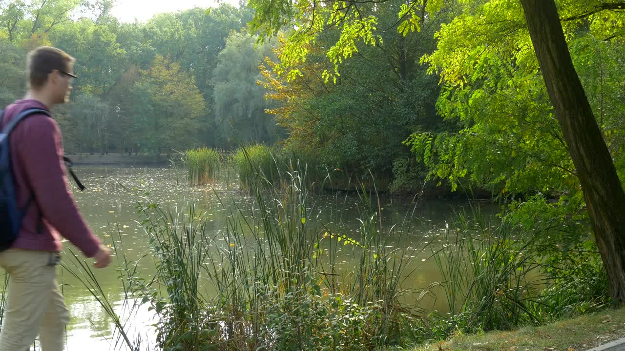 Stock Video Man Walking By The Riverside Takes A Brea Animated Wallpaper