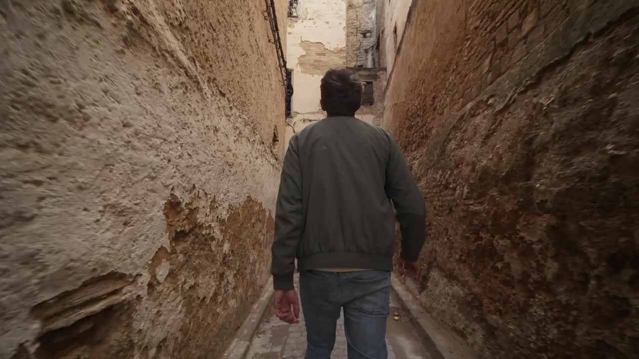 Stock Video Man Walking Along An Old Narrow Alley Trackin Animated Wallpaper
