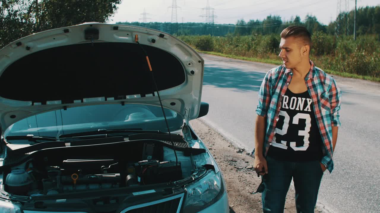 Stock Video Man Waits By His Broken Ca Animated Wallpaper