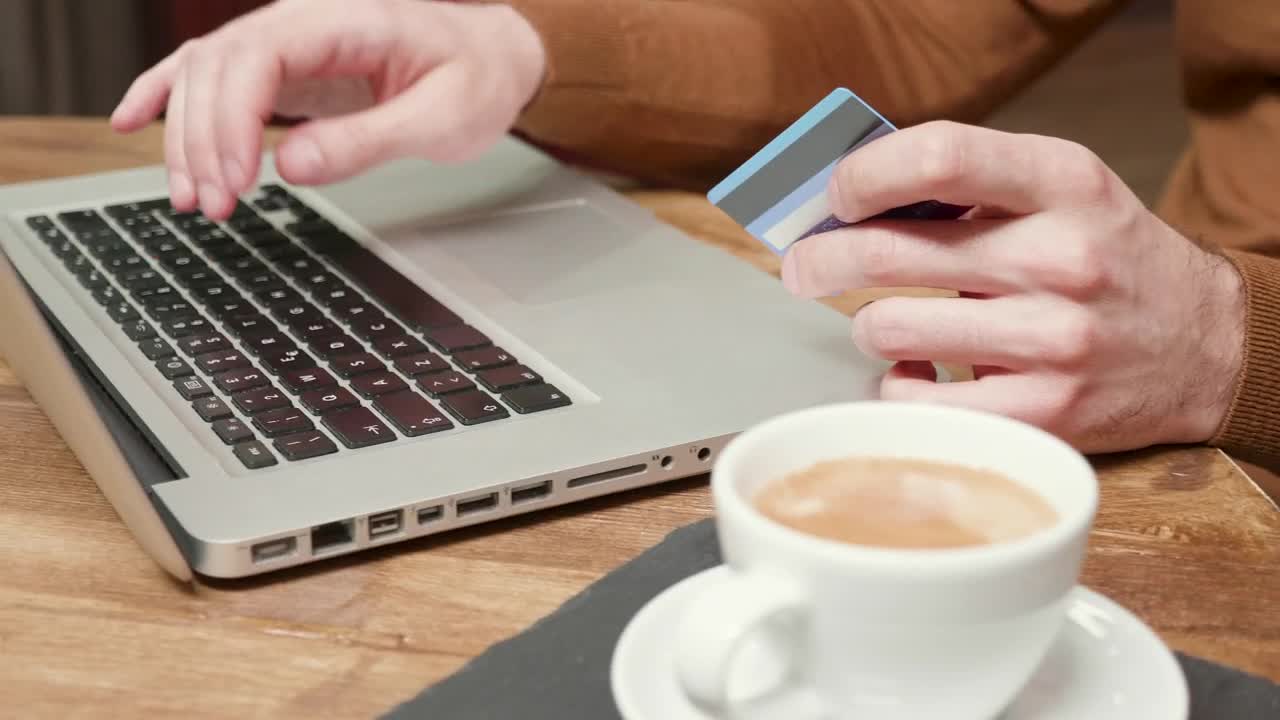Stock Video Man Using Online Pay With Credit Card In Caf Animated Wallpaper