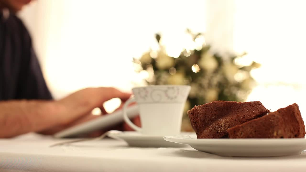 Stock Video Man Using His Table During Breakfas Animated Wallpaper