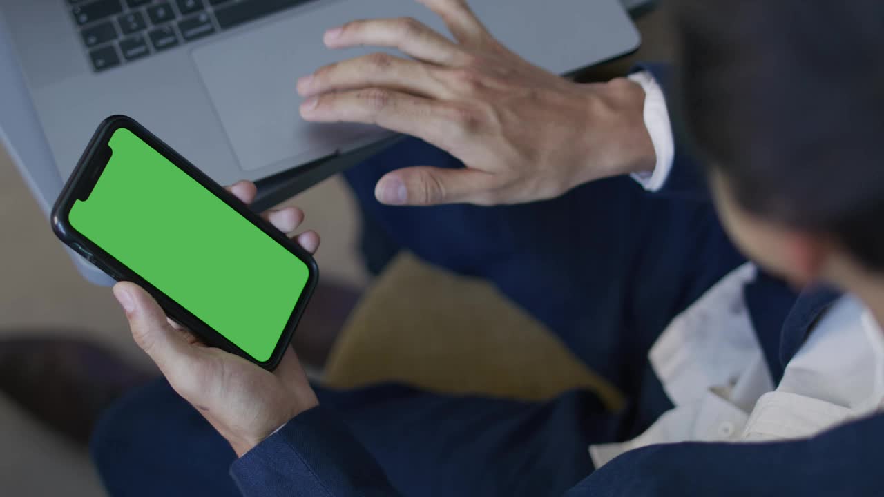 Stock Video Man Using His Computer And Cell Phon Animated Wallpaper