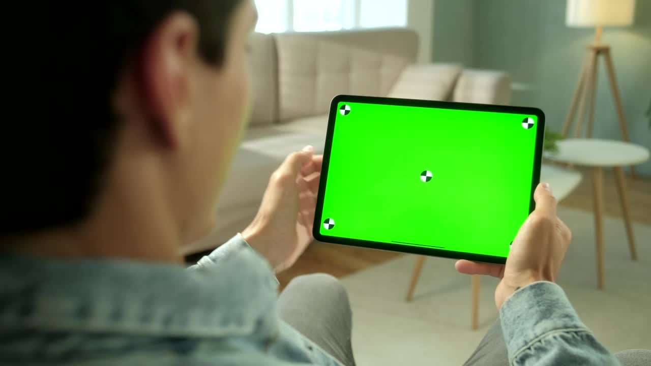 Stock Video Man Using Green Screen Tablet In Neutral Living Roo Animated Wallpaper