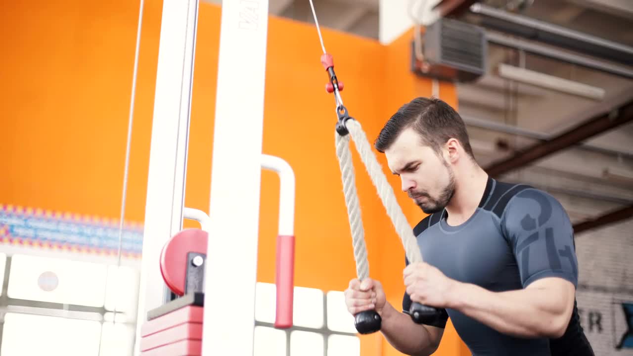 Stock Video Man Training With A Pull Down Weight Machin Animated Wallpaper